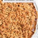 close up of half of baked apple pie with graham cracker crust