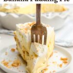 fork piercing slice of banana pudding pie on white plate.