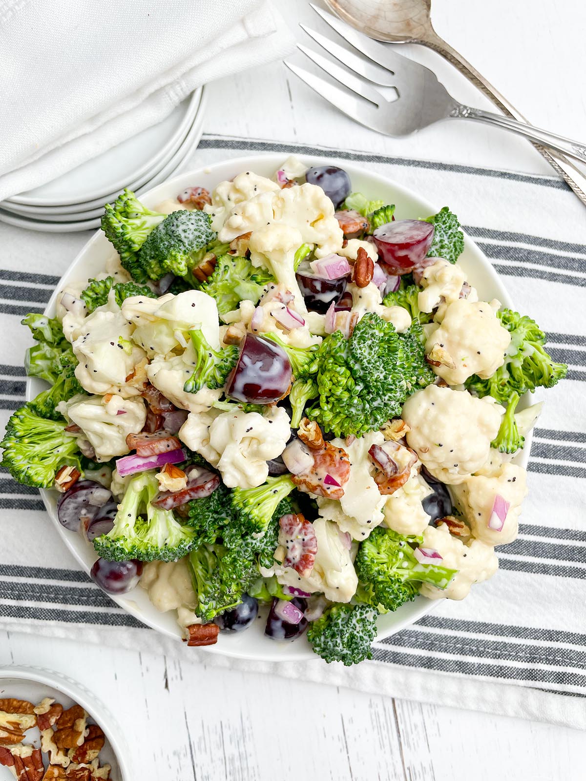 Broccoli cauliflower bacon salad in a white bowl