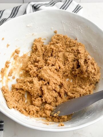 Browned butter peanut butter cookie dough in a white mixing bowl.