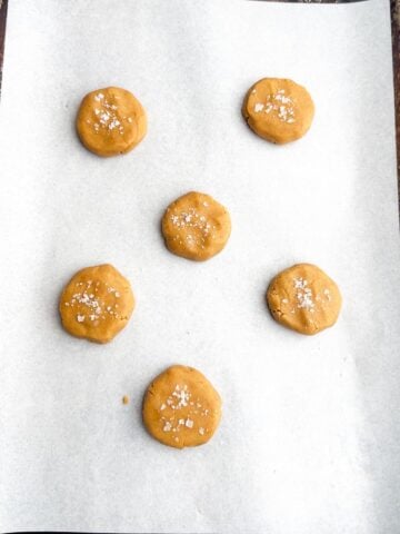 Browned butter peanut butter cookie dough balls on a baking sheet.