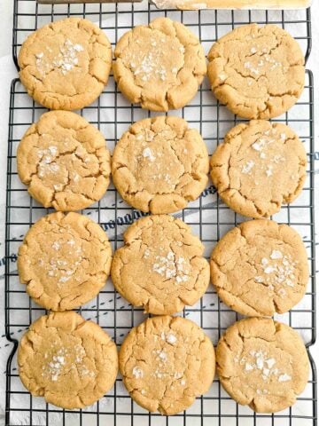 Browned butter peanut butter cookies on a wire baking rack.