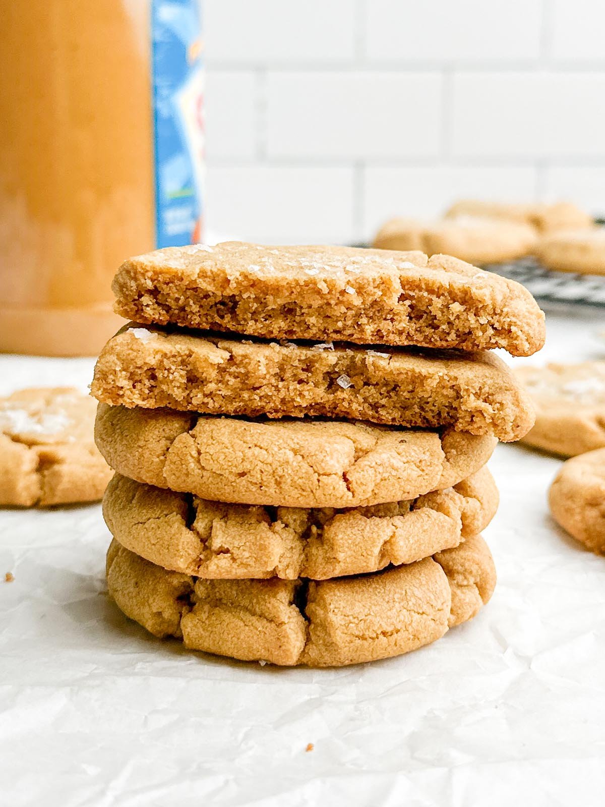 Stack of browned butter peanut butter cookies on white countertop.