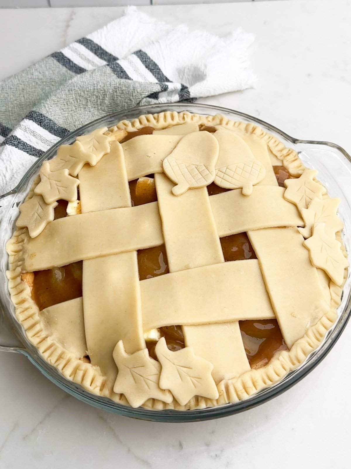 Lattice topped apple pie with pie dough cutouts.
