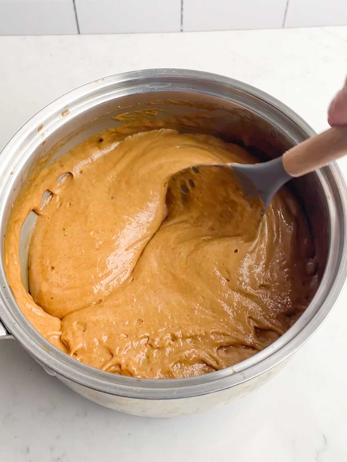 stirring caramel mixture in a large sauce pan