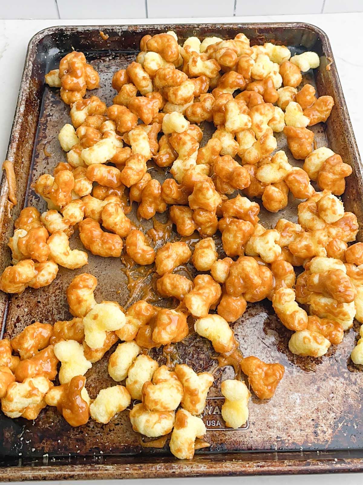 Caramel Puff Corn Recipe without Corn Syrup spread onto a sheet pan
