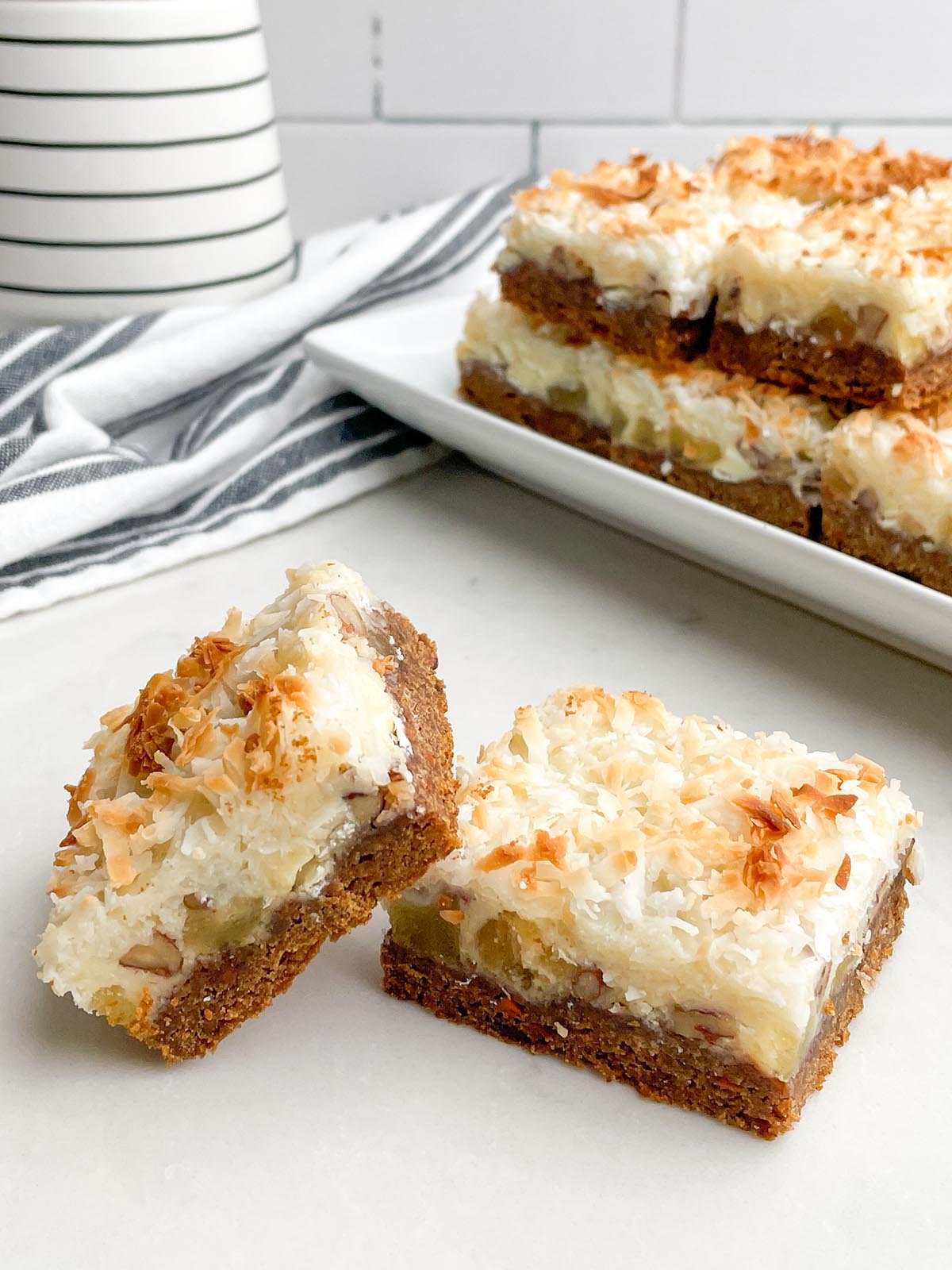 two carrot cake mix bars on a a white counter top.