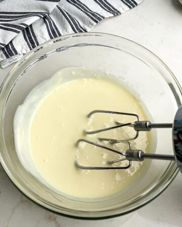 cream cheese and condensed milk mixture in a clear bowl. 