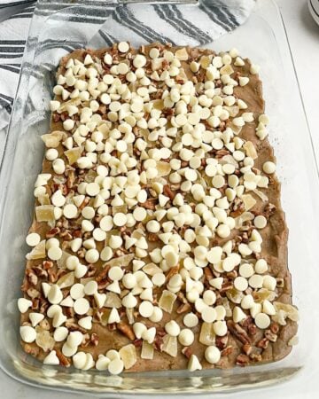 carrot cake batter layered with pecans, pineapple, and white chocolate chips in a 9 x 13 pan. 