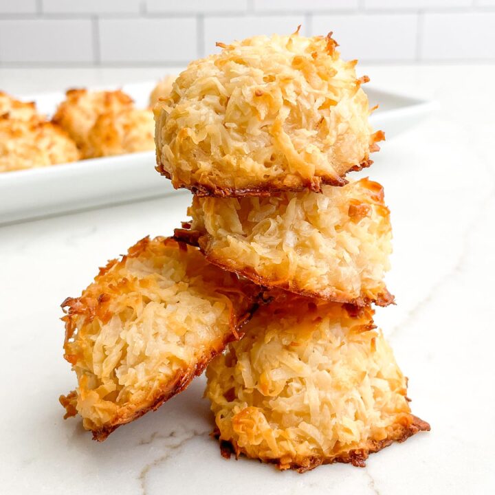 stack of chewy coconut macaroons on a white countertop.