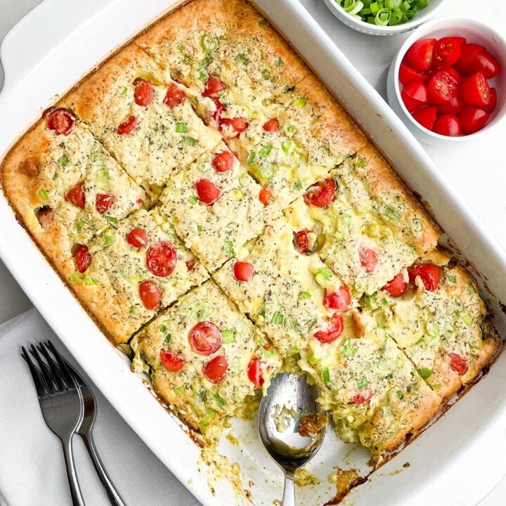baked chicken zucchini casserole cut into squares in white baking dish