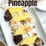 chocolate covered pineapple half rings on a white platter