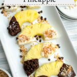 chocolate covered pineapple half rings on a white platter