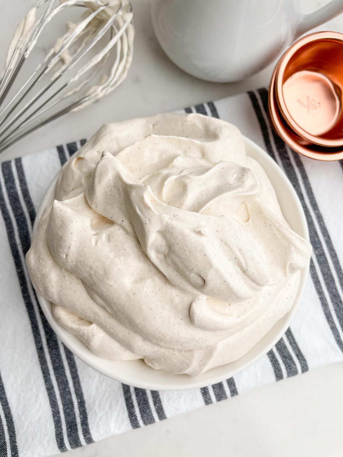 cinnamon whipped cream in a white bowl.