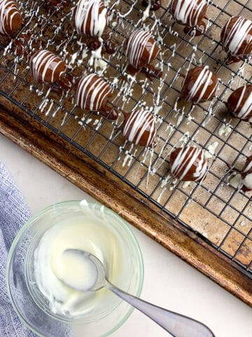 no bake chocolate coconut balls on a wire rack. 