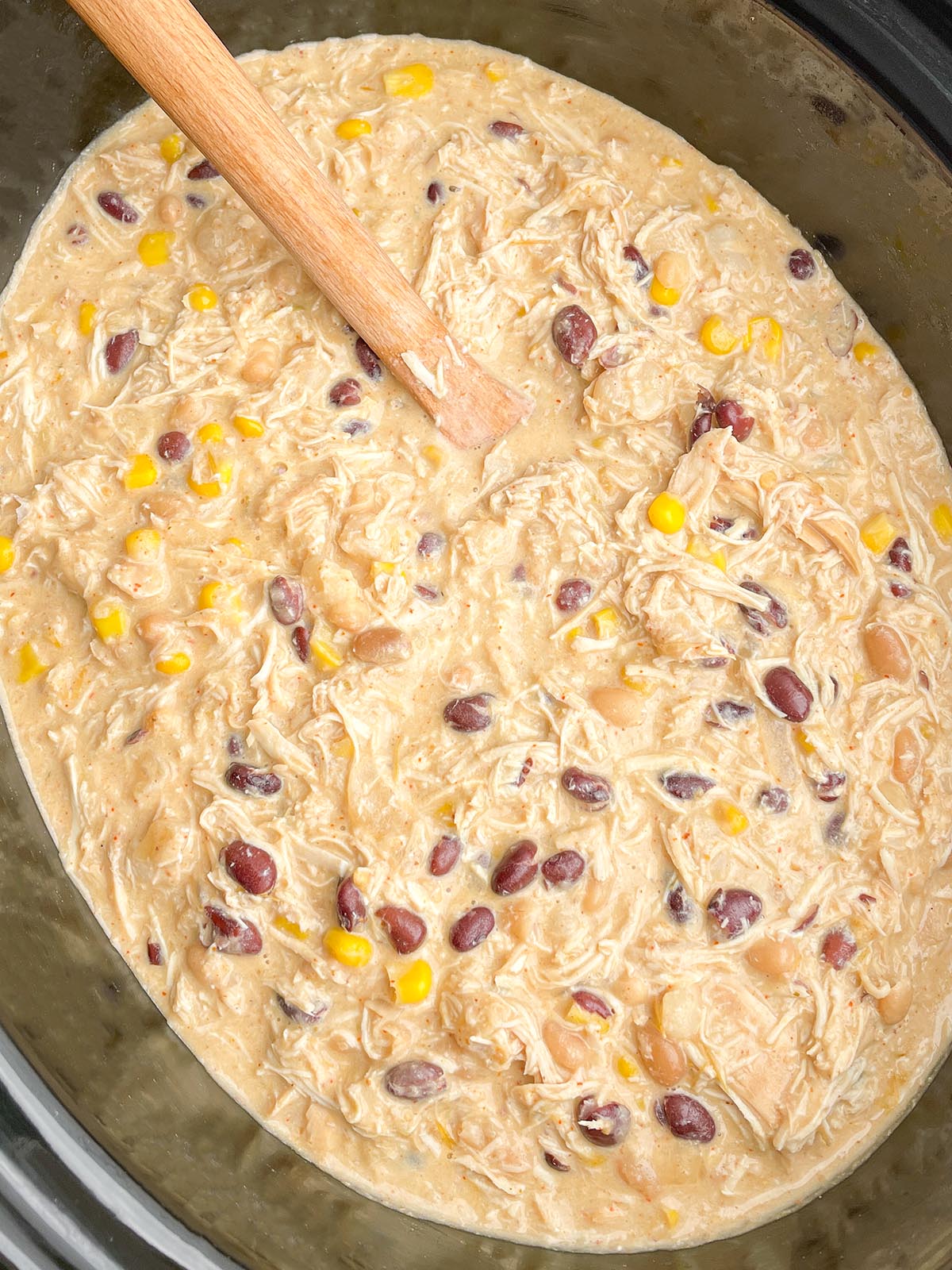 cream cheese chicken chili in a black slow cooker