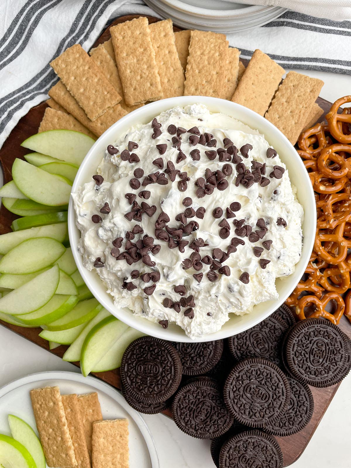 white bowl of chocolate chip dip on a tray of dippers