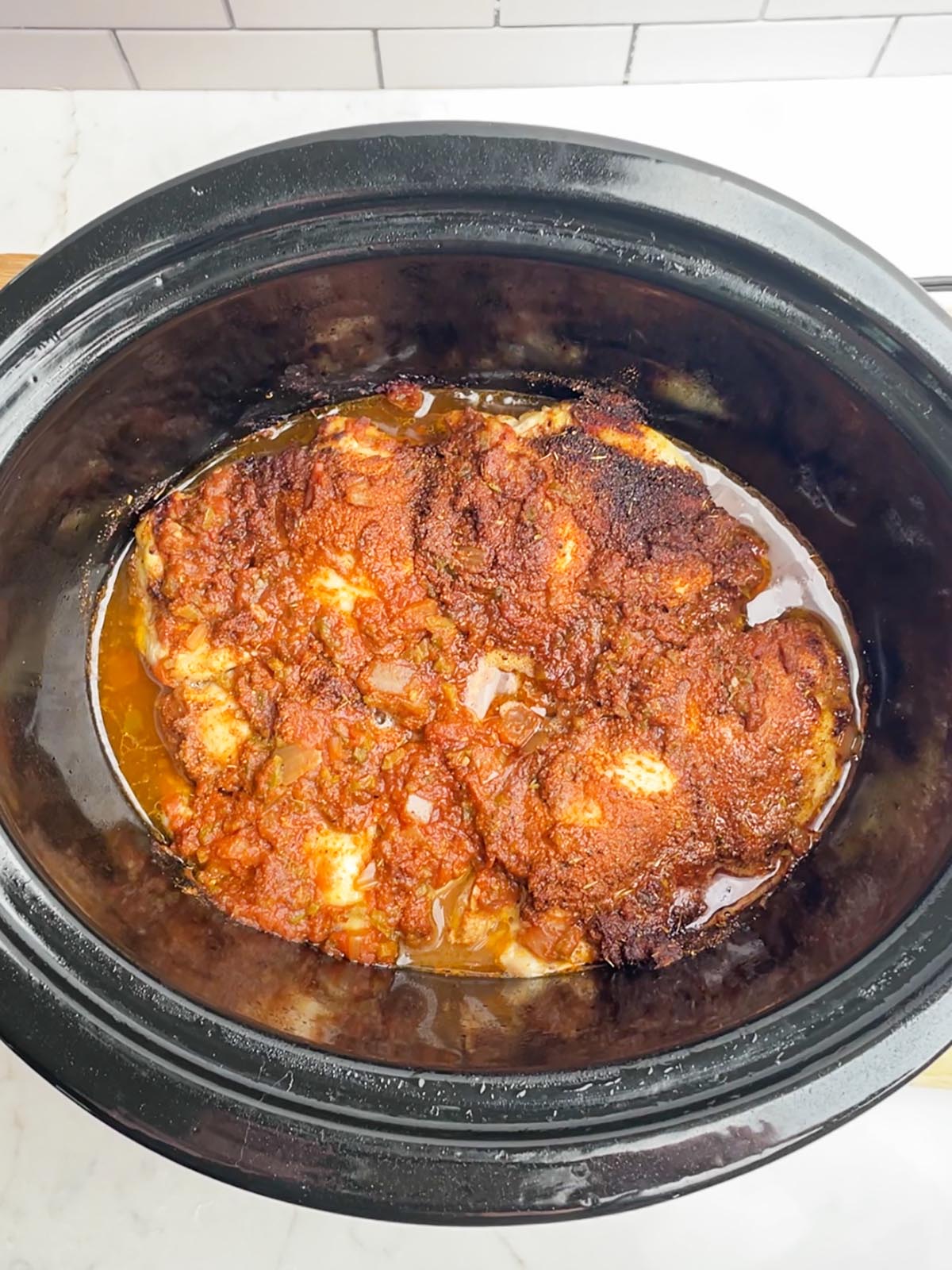 crock pot salsa chicken in black slow cooker