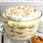easy banana pudding in a trifle dish on a blue and white napkin