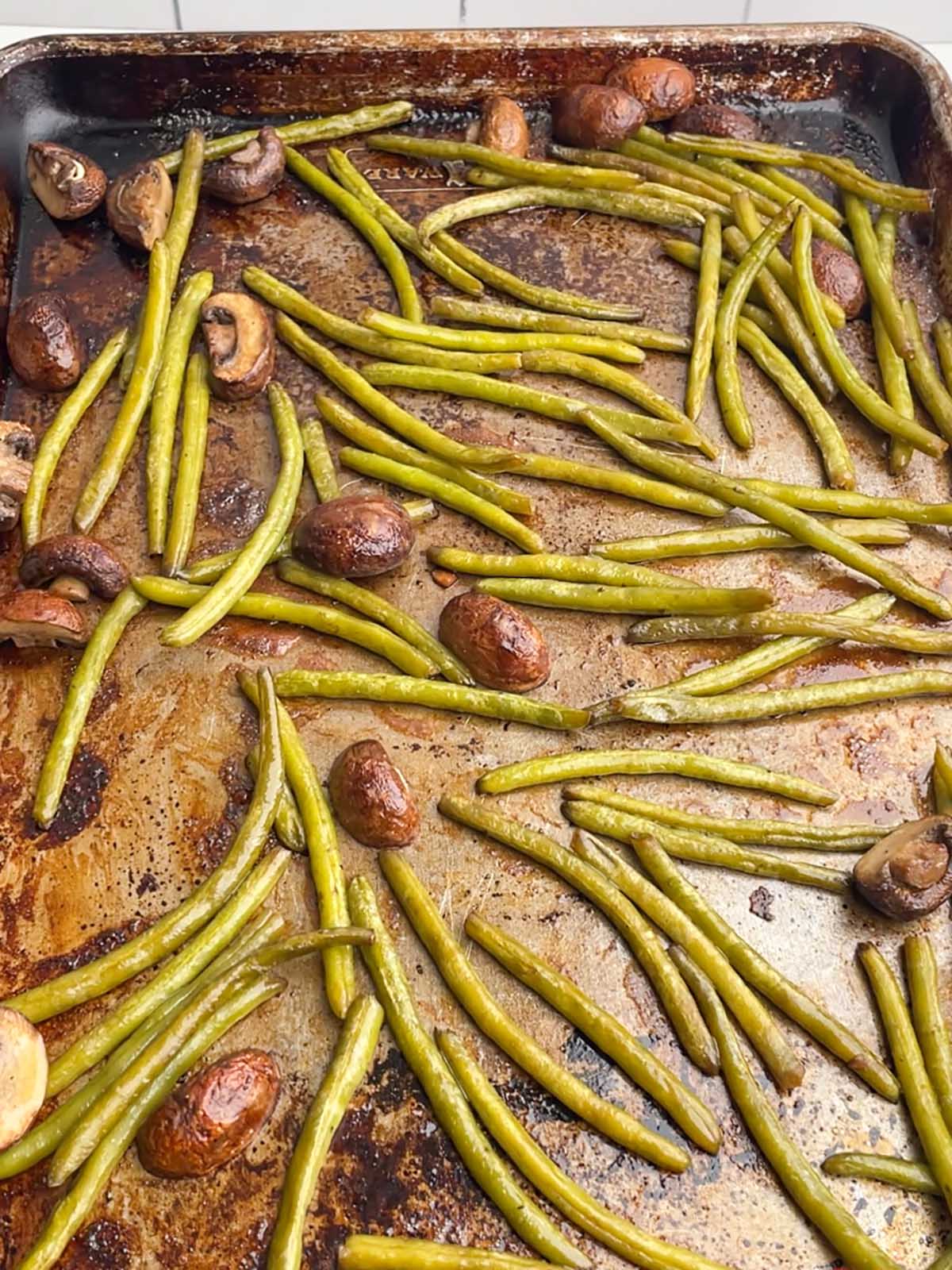 green beans and mushrooms on a sheet pan