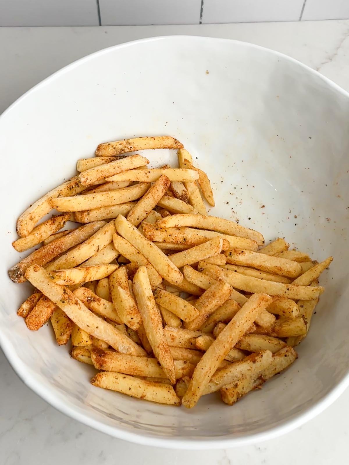 frozen seasoned fries in white bowl