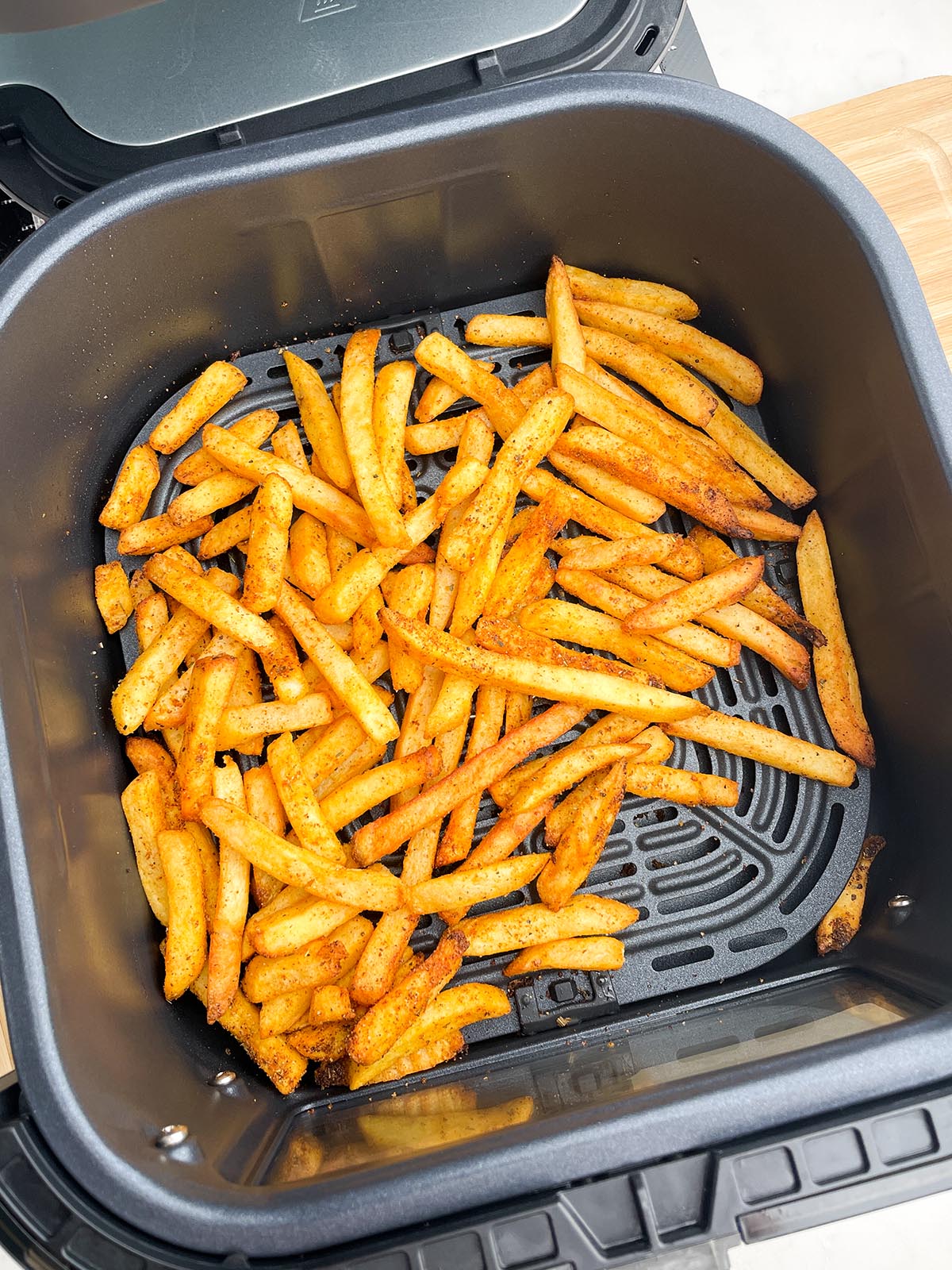 cooked frozen seasoned fries in air fryer basket