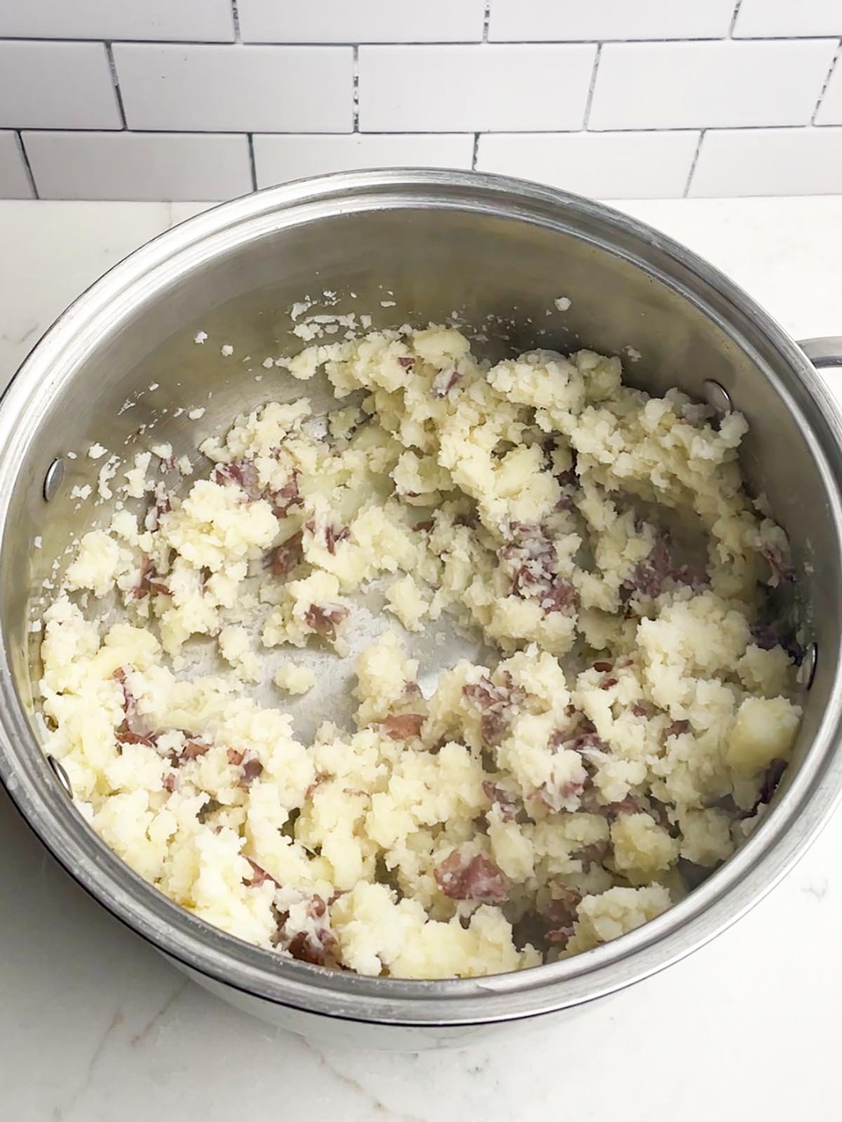 mashed red potatoes in stainless stock pot