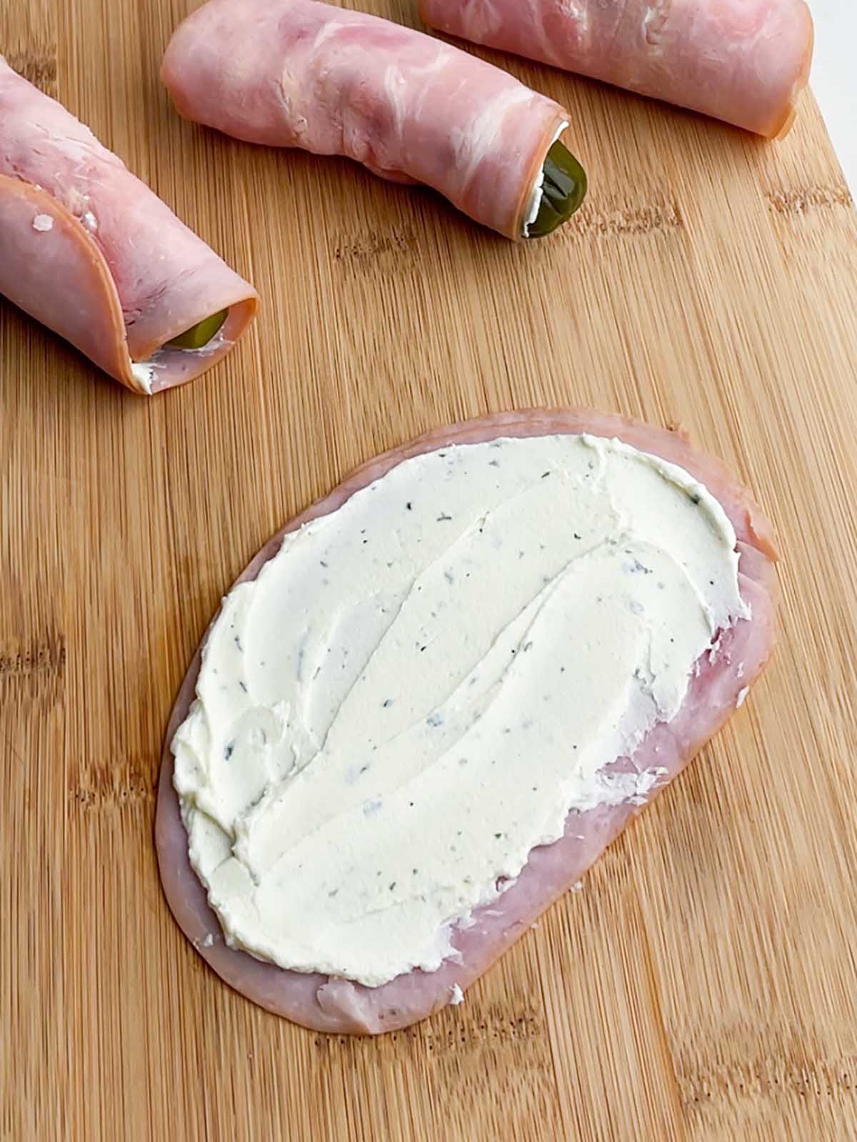cream cheese spread on a slice of ham
