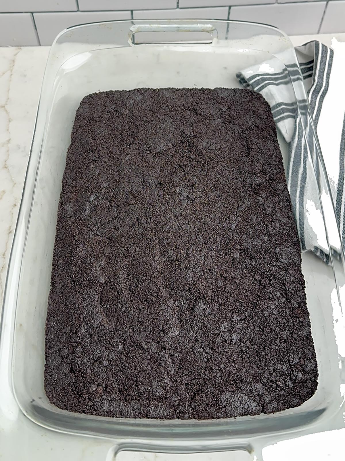 Oreo crust in a clear baking pan