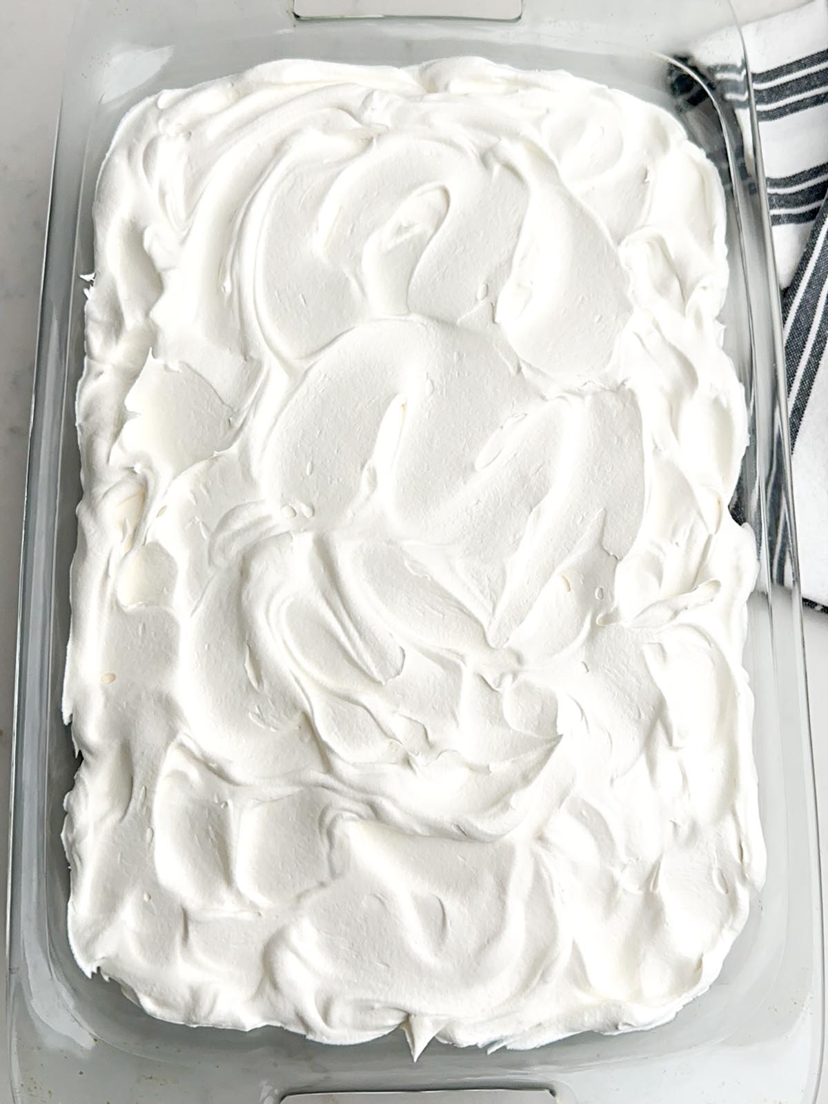 Cool Whip layer spread over pudding layer