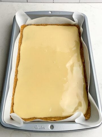 sweetened condensed milk over a graham cracker crust in a 9 x 13 pan.