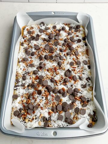 chocolate chips layered over pecans and coconut in 9 x 13 pan.