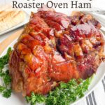 glazed roaster oven ham on a white platter