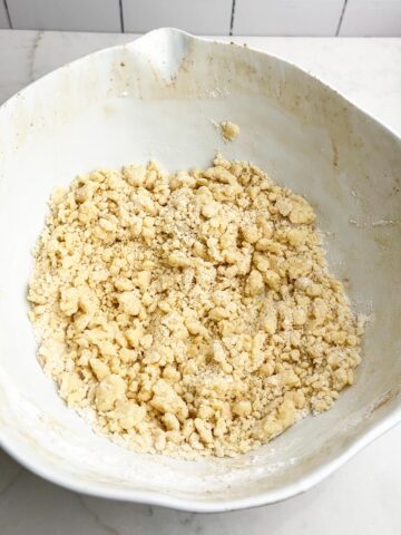 cake mix and butter mixture in a white mixing bowl.