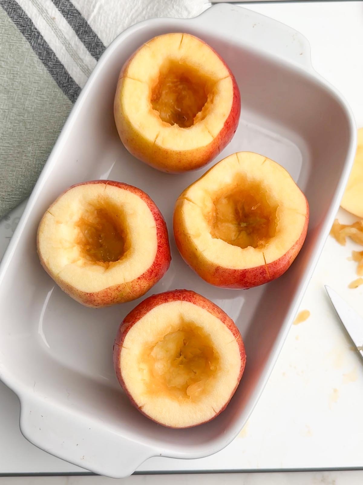 cored apples in a baking dish