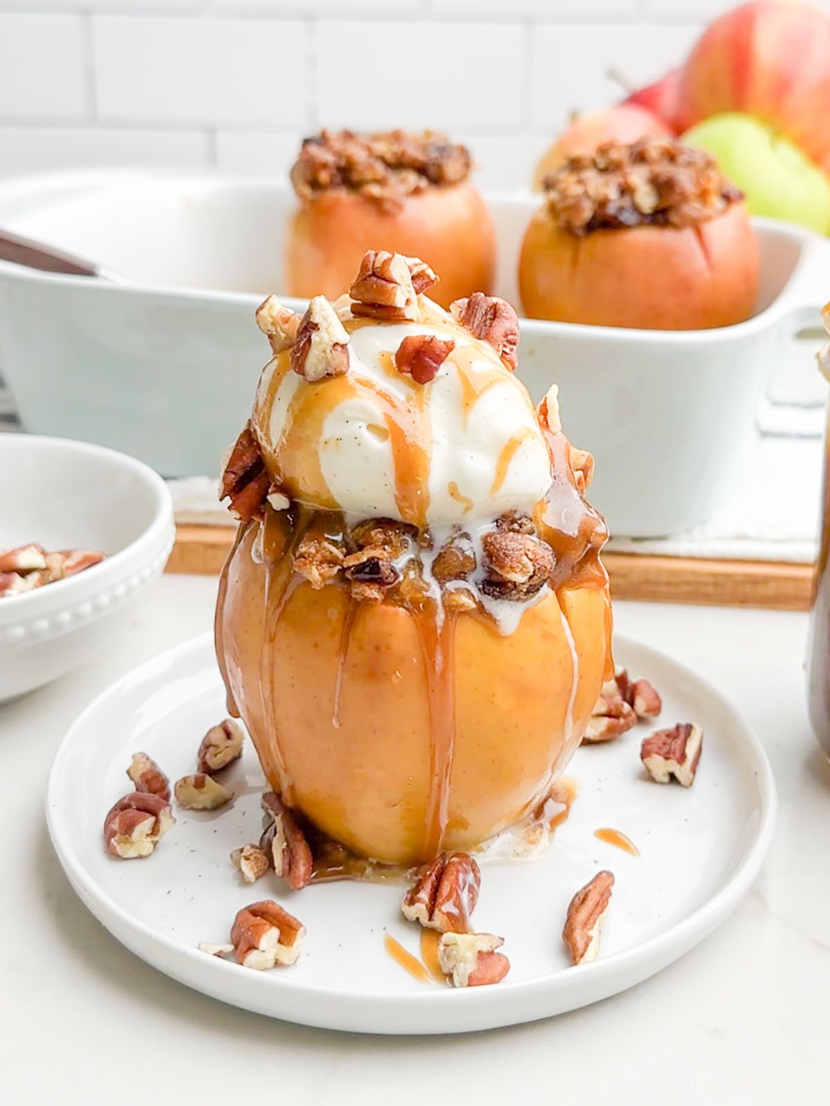 baked cinnamon apple topped with ice cream and caramel sauce