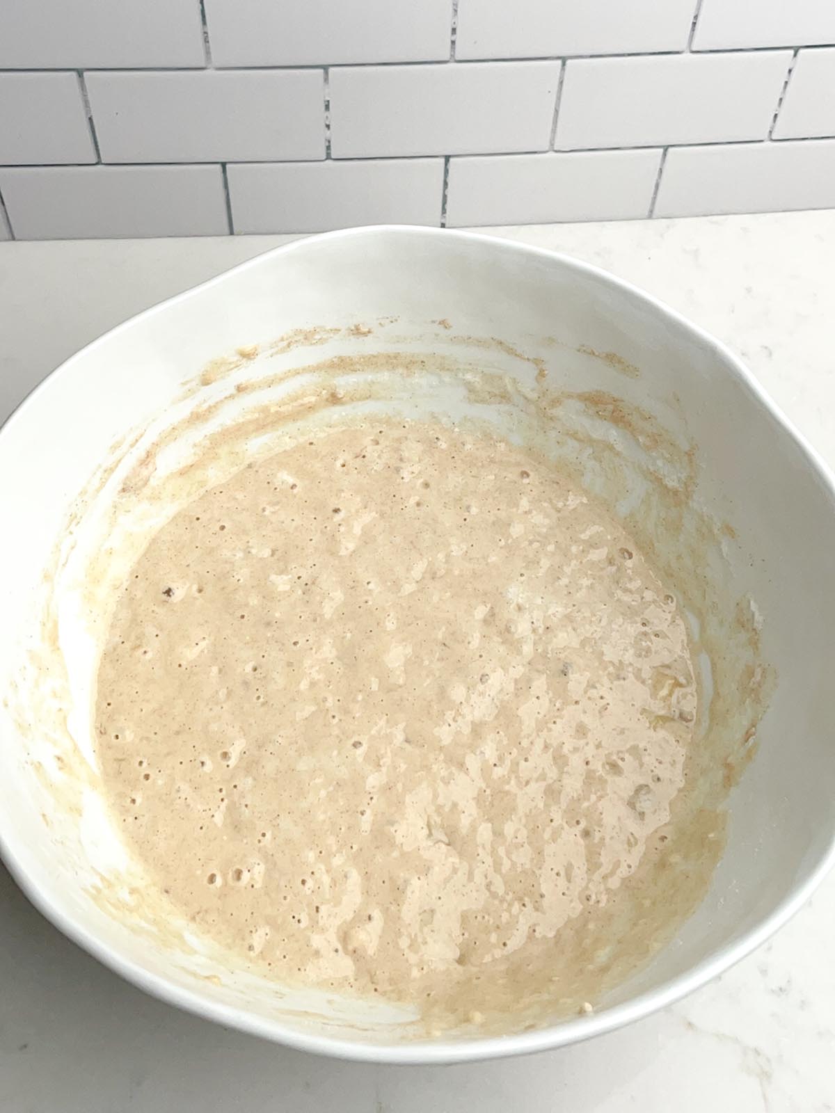 banana pancake batter in white mixing bowl.