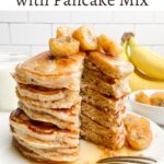 stack of banana pancakes from pancake mix topped with bananas and maple syrup