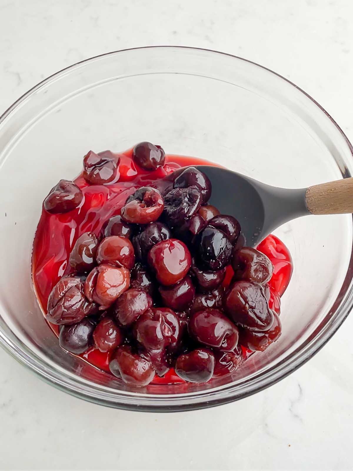 cherry pie filling with thawed cherries in a clear bowl