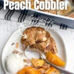 white plate with peach cobbler and ice cream