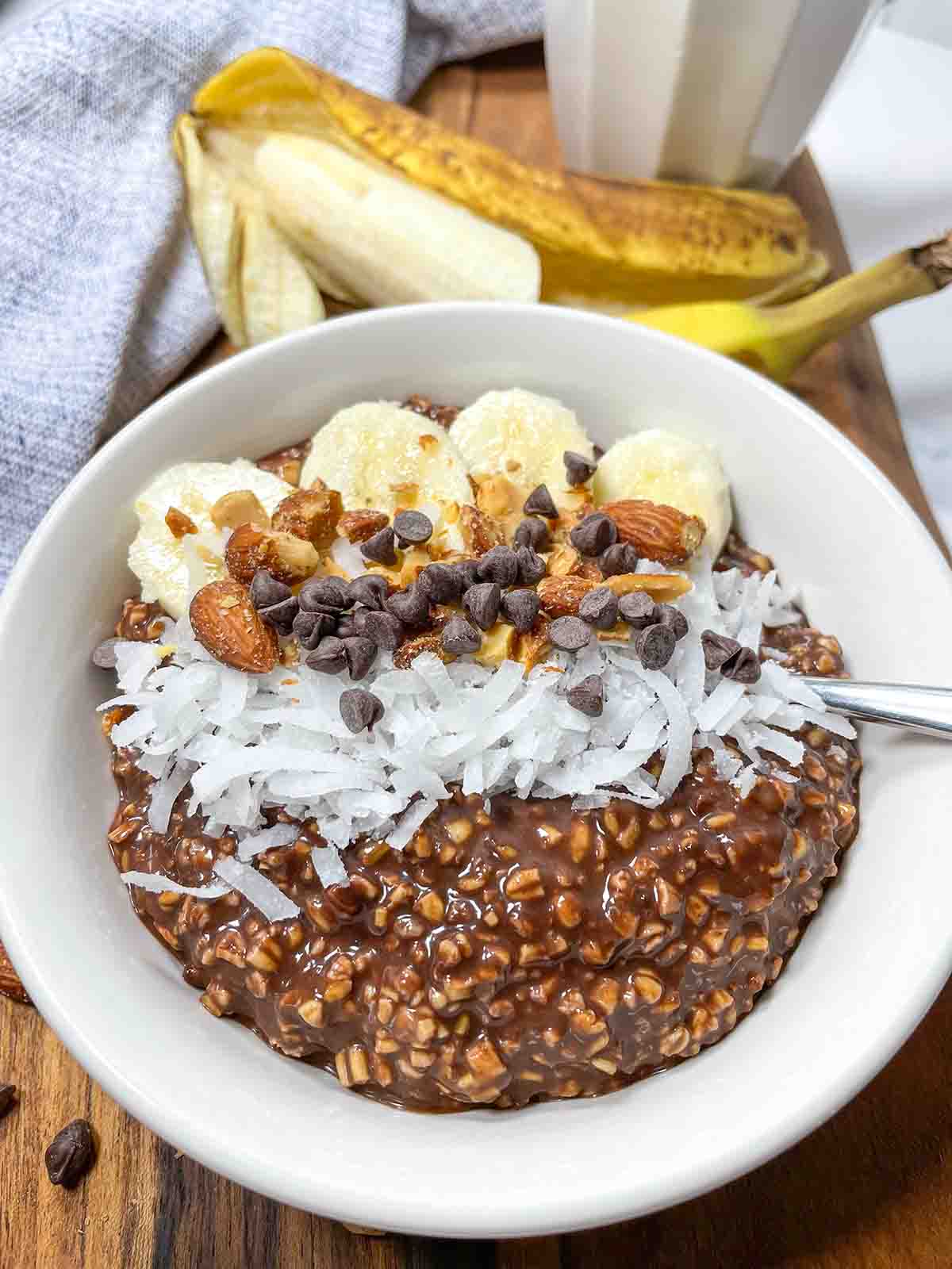 Chocolate Banana Overnight Oats with almonds, bananas, coconut, and mini chocolate chips