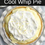 lemon jello pie topped with cool whip and lemon zest on a blue and white tea towel