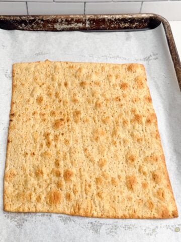 browned lavash flatbread on sheet pan lined with parchment paper.