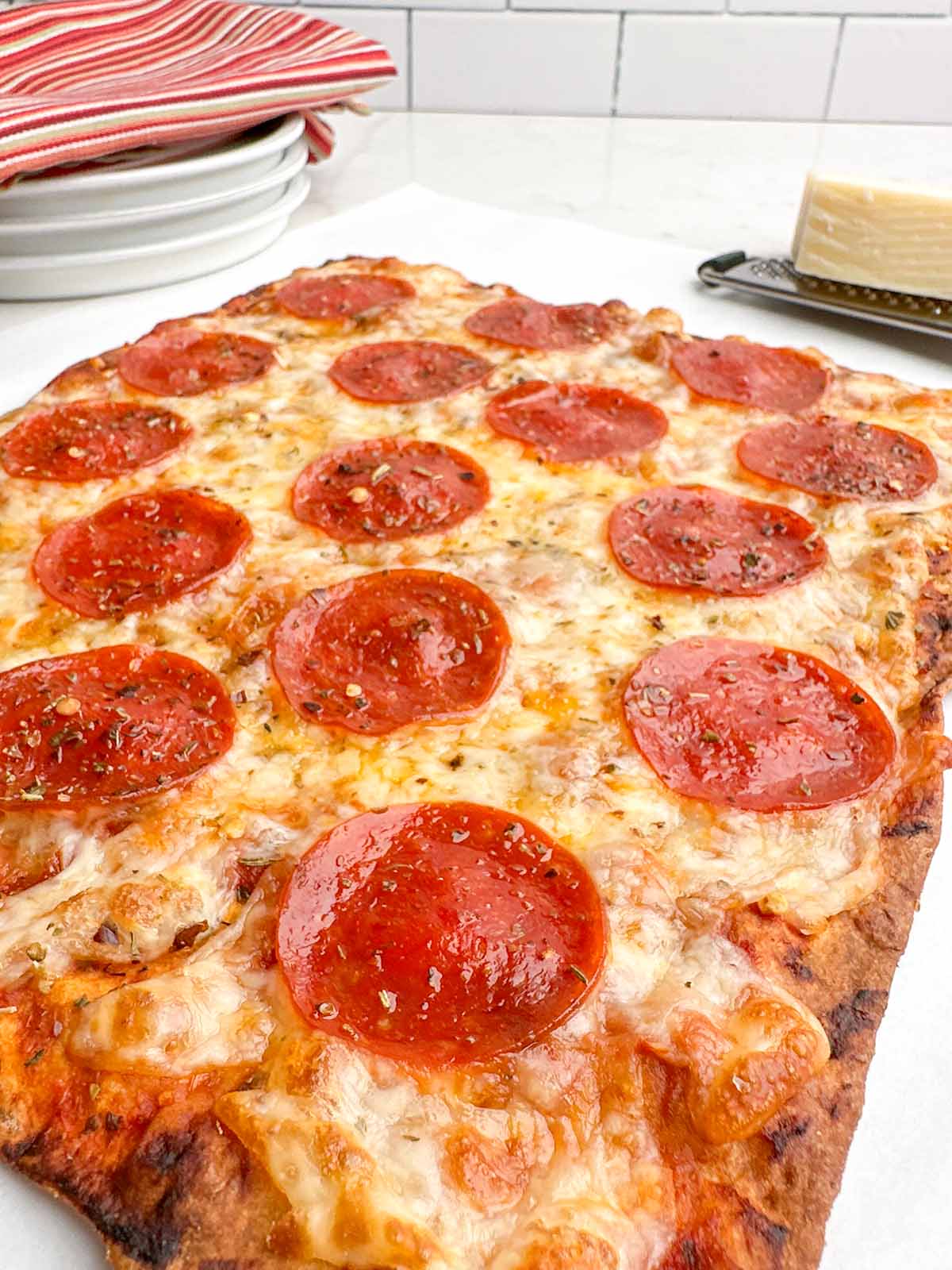 eye level view of freshly baked pepperoni lavash pizza.