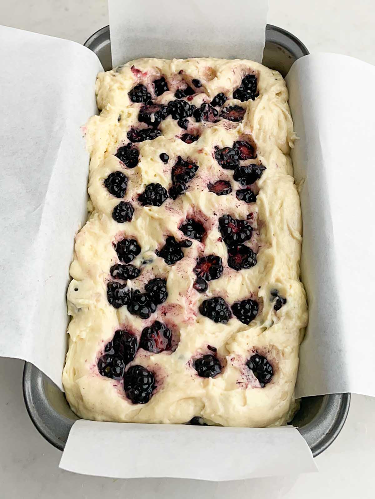 lemon blackberry bread batter in a loaf pan