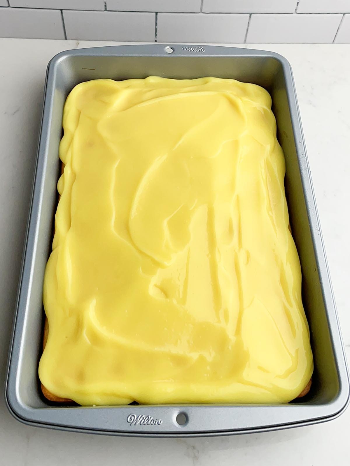 white cake withe lemon pudding spread on top