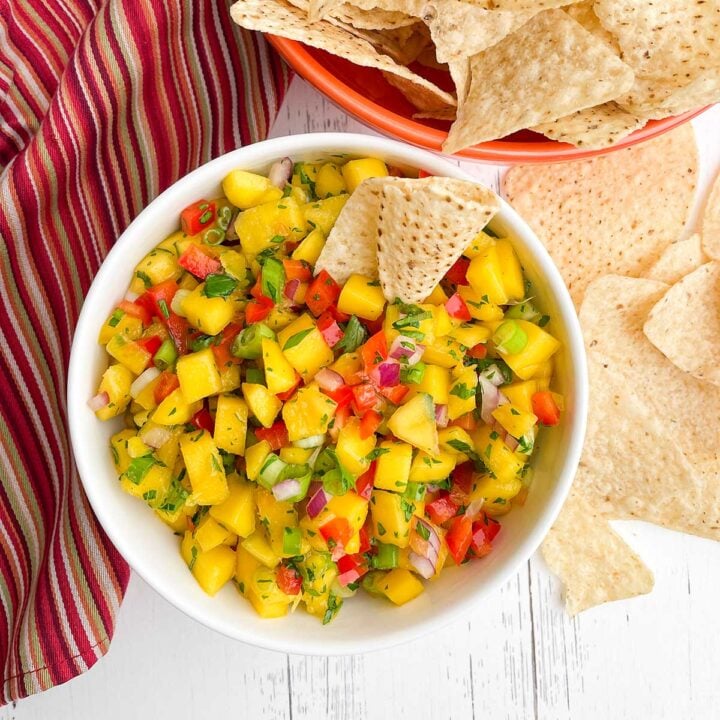 Mango Habanero Salsa recipe in a white bowl with tortilla chips