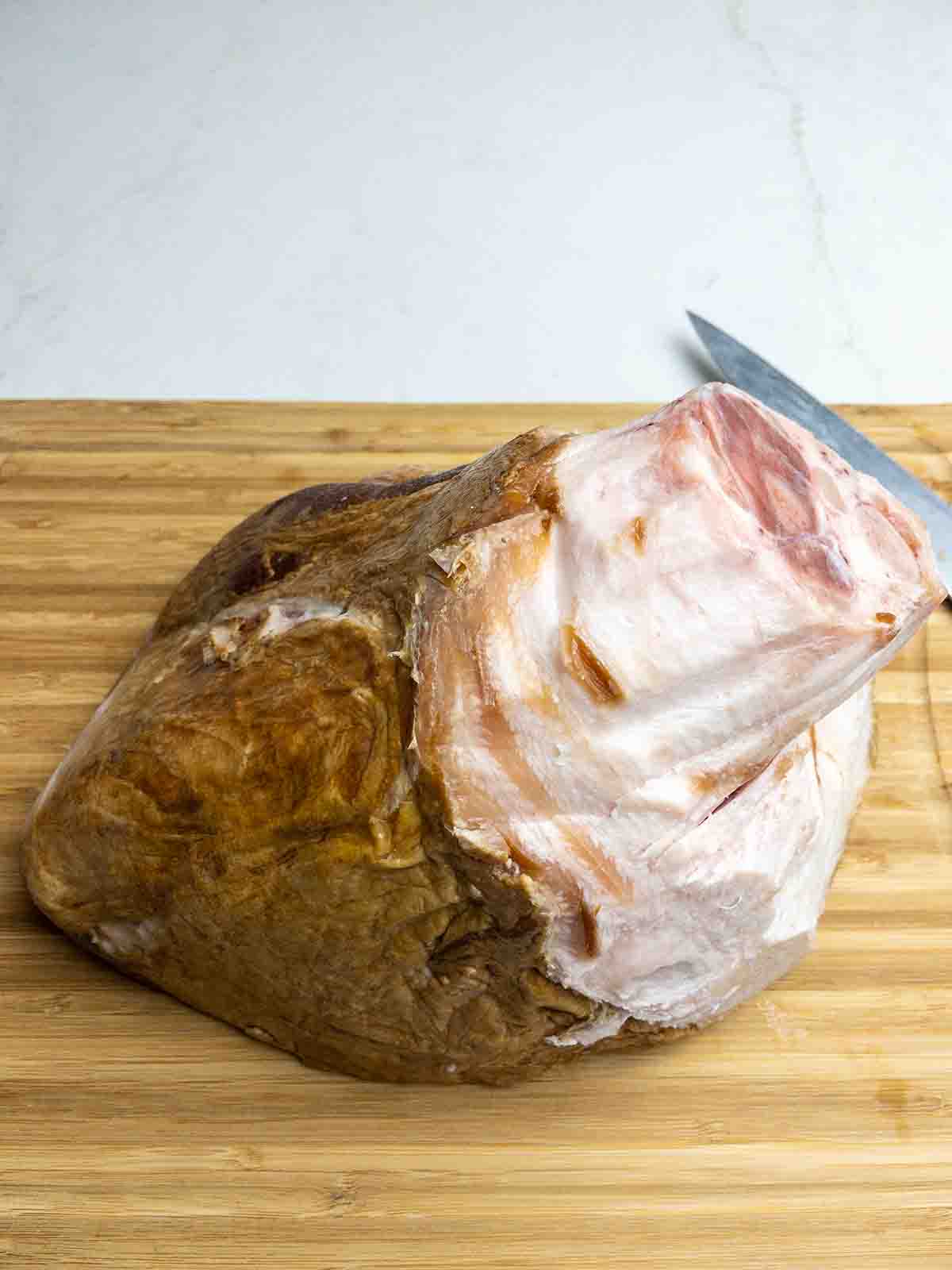 ham on a cutting board with the rind cut off