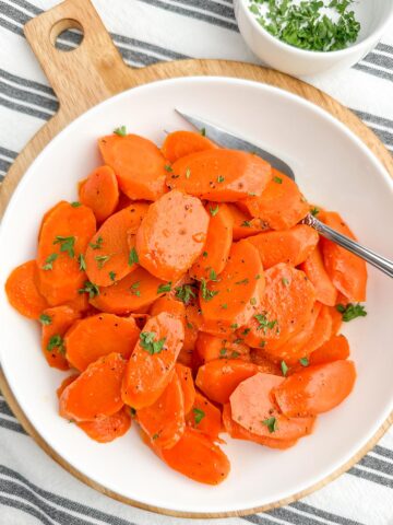 microwave steamed carrots on a white plate.