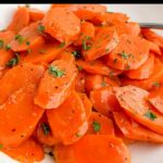 microwave steamed carrots on a white plate.